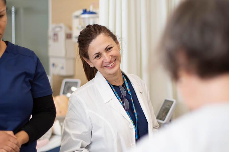 Nursing student standing in lab