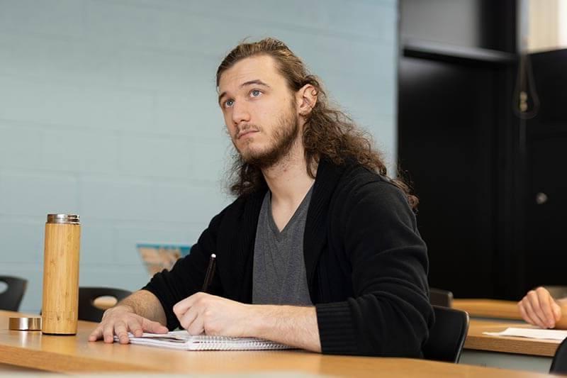 male student listening in class